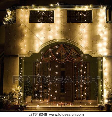 Stock Photo - Decorated entrance of a house lit up at night. Fotosearch