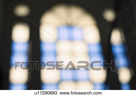 Stock Image - Defocused view of a stained glass window. Fotosearch