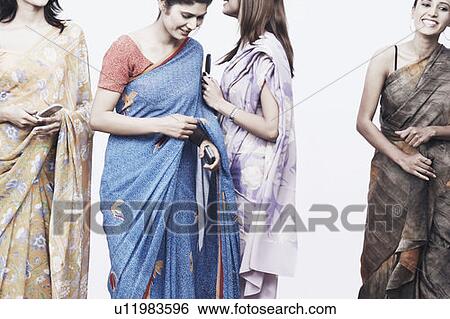 Stock Photograph - Four young women holding mobile phones. Fotosearch