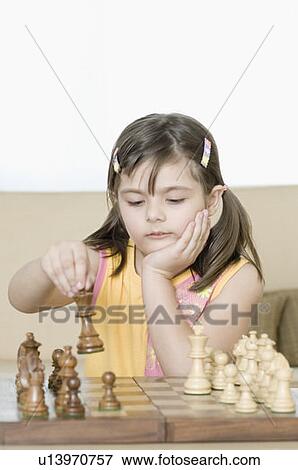 Stock Photo - Girl playing chess. Fotosearch