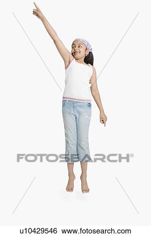 Stock Photograph - Girl pointing upwards. Fotosearch