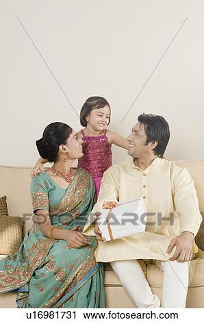 Stock Image - Girl smiling with her parents. Fotosearch