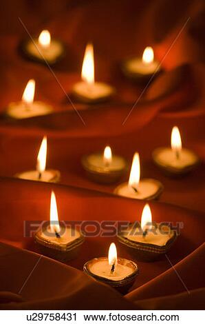 Stock Image - Group of burning oil lamps. Fotosearch