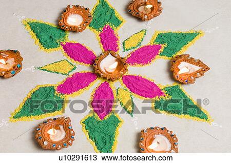 Stock Image - High angle view of a diwali rangoli decorated with oil lamps. Fotosearch
