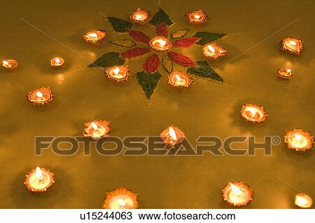 Stock Image - High angle view of a diwali rangoli decorated with oil lamps. Fotosearch