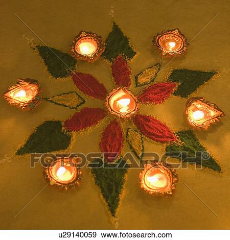 Stock Photo - High angle view of a diwali rangoli decorated with oil lamps. Fotosearch