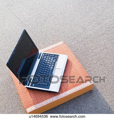 Stock Photograph - High angle view of a laptop on a cushion. Fotosearch