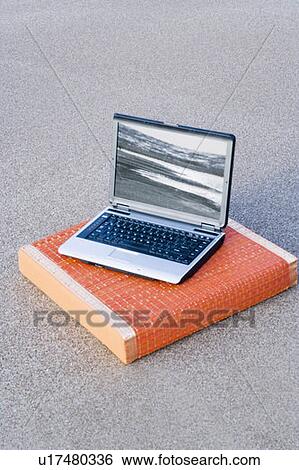 Stock Photograph - High angle view of a laptop on a cushion. Fotosearch