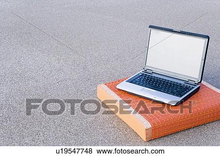 Stock Photo - High angle view of a laptop on a wooden block. Fotosearch