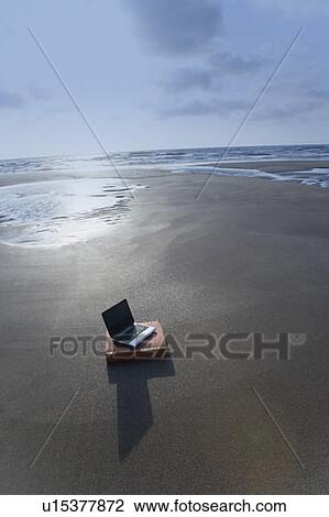 Stock Image - High angle view of a laptop on the beach. Fotosearch