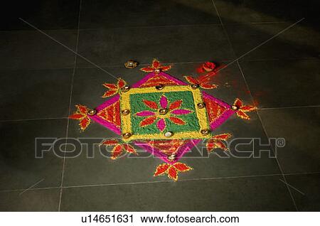 Stock Image - High angle view of a rangoli on the floor. Fotosearch