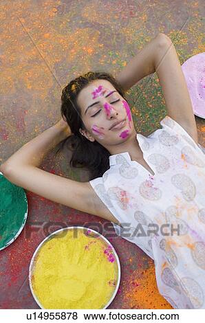 High angle view of a young woman lying down with her hands behind her head View Large Photo Image Stock Photo - High angle view of a young woman lying down with her hands behind her head. Fotosearch