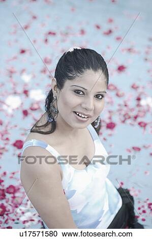 High angle view of a young woman standing in a swimming pool View Large Photo Image Stock Image - High angle view of a young woman standing in a swimming pool. Fotosearch