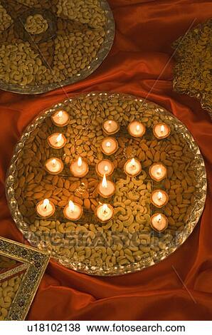 High angle view of oil lamps in a dry fruit's plate View Large Photo Image Stock Photo - High angle view of oil lamps in a dry fruit's plate. Fotosearch