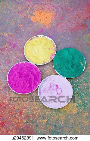 Stock Image - High angle view of powder paint in plates. Fotosearch