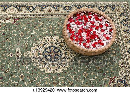 Stock Image - High angle view of rose petals in a bowl. Fotosearch