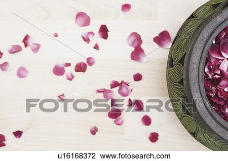 Stock Image - High angle view of rose petals in a pot. Fotosearch