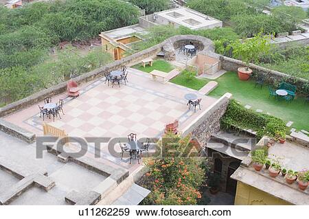 Stock Photo - High angle view of tables and chairs on the roof of a palace, Neemrana Fort Palace, Neemrana, Alwar, Rajasthan, India. Fotosearch