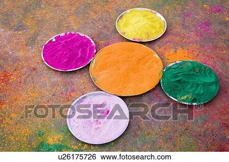 Stock Photograph - High angle view of various powder paints in plates on Holi festival. Fotosearch