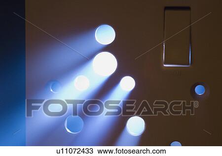 Stock Image - Light beam coming out from a switchboard. Fotosearch