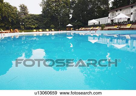 Stock Photo - Lounge chairs at the poolside. Fotosearch
