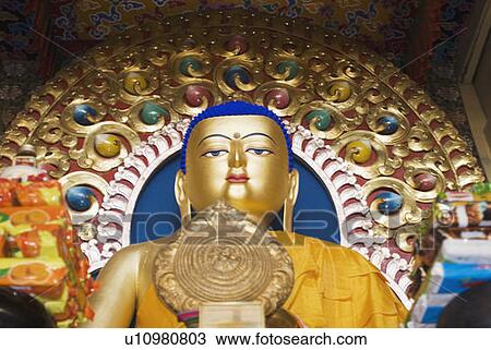Stock Image - Low angle view of a statue of Buddha in a temple, Namgyal Monastery, McLeod Ganj, Dharamshala, Himachal Pradesh, India. Fotosearch