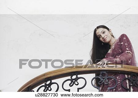 Low angle view of a teenage girl standing in a balcony View Large Photo Image Stock Image - Low angle view of a teenage girl standing in a balcony. Fotosearch