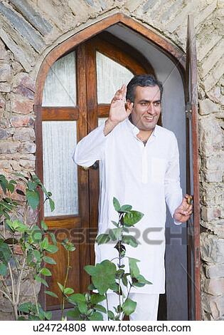 Stock Photo - Mid adult man waving his hand. Fotosearch