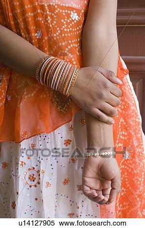 Mid section view of a teenage girl wearing bangles View Large Photo Image Stock Photography - Mid section view of a teenage girl wearing bangles. Fotosearch