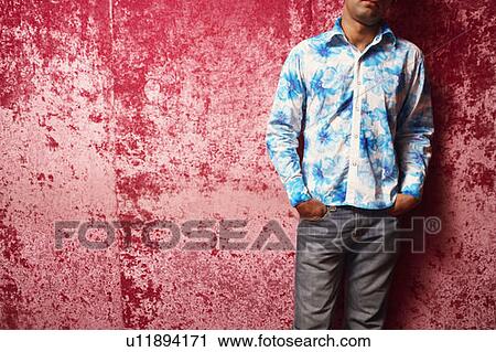 Stock Image - Mid section view of a young man standing. Fotosearch