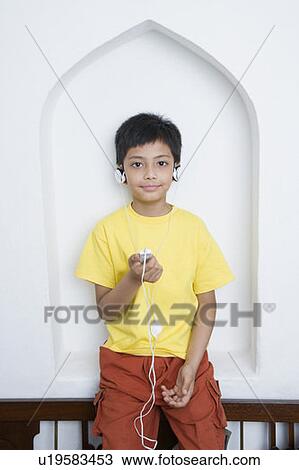 Portrait of a boy listening to an MP3 player View Large Photo Image Stock Image - Portrait of a boy listening to an MP3 player. Fotosearch