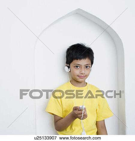 Portrait of a boy listening to an MP3 player View Large Photo Image Stock Photo - Portrait of a boy listening to an MP3 player. Fotosearch