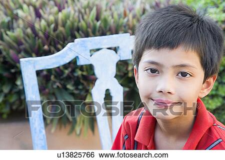 Stock Photograph - Portrait of a boy smirking. Fotosearch