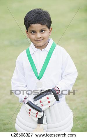 Portrait of a boy standing with a medal around his neck and smiling View Large Photo Image Stock Photo - Portrait of a boy standing with a medal around his neck and smiling. Fotosearch
