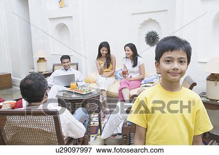Stock Photo - Portrait of a boy with his family sitting behind him. Fotosearch