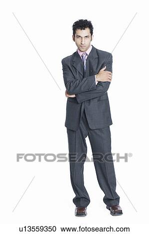 Stock Image - Portrait of a businessman standing with his arms crossed. Fotosearch
