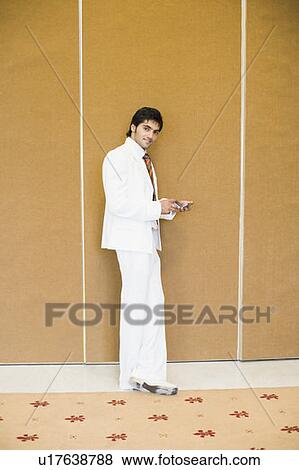 Stock Photo - Portrait of a businessman using a mobile phone. Fotosearch