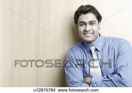 Portrait of a businessman with his arms folded View Large Photo Image Picture - Portrait of a businessman with his arms folded. Fotosearch