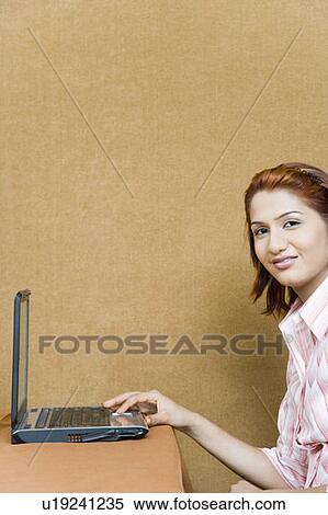 Stock Photography - Portrait of a businesswoman using a laptop. Fotosearch
