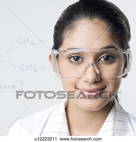 Portrait of a female lab technician wearing a protective eyewear View Large Photo Image Stock Image - Portrait of a female lab technician wearing a protective eyewear. Fotosearch