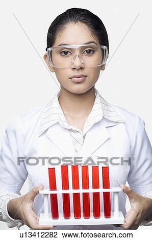 Portrait of a female lab technician holding a test tube rack View Large Photo Image Stock Image - Portrait of a female lab technician holding a test tube rack. Fotosearch