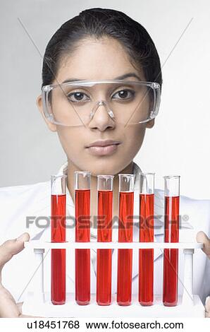 Portrait of a female lab technician holding a test tube rack View Large Photo Image Stock Photo - Portrait of a female lab technician holding a test tube rack. Fotosearch