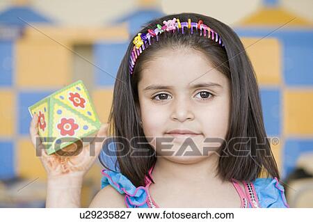 Stock Photo - Portrait of a girl holding a paper craft product. Fotosearch