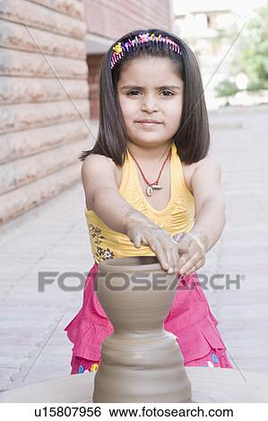 Stock Photograph - Portrait of a girl making a pottery. Fotosearch