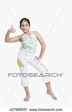 Stock Photo - Portrait of a girl posing and showing thumbs up sign. Fotosearch