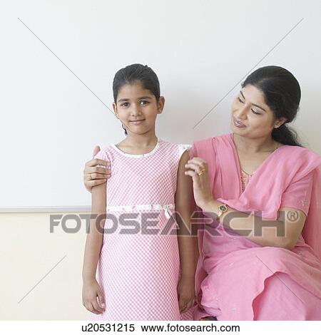 Portrait of a girl standing beside her teacher View Large Photo Image Stock Photography - Portrait of a girl standing beside her teacher. Fotosearch