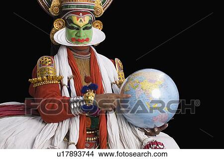 Picture - Portrait of a Kathakali dance performer holding a globe. Fotosearch