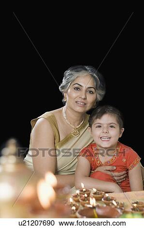 Portrait of a mature woman sitting with her granddaughter and smiling View Large Photo Image Stock Image - Portrait of a mature woman sitting with her granddaughter and smiling. Fotosearch