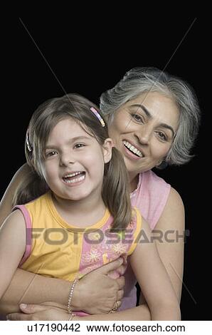 Portrait of a mature woman smiling with her granddaughter View Large Photo Image Stock Image - Portrait of a mature woman smiling with her granddaughter. Fotosearch