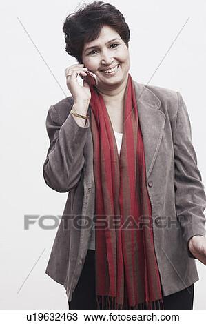 Portrait of a mature woman talking on a mobile phone View Large Photo Image Stock Image - Portrait of a mature woman talking on a mobile phone. Fotosearch